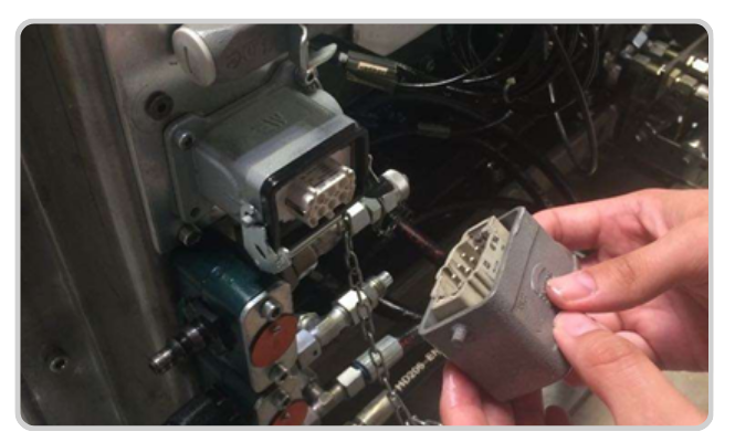 Coded PLC connector — physical fixture-to-program interlock at Op 20